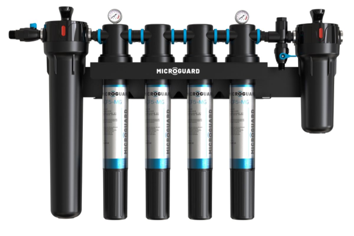 Microguard multi-stage commercial water filtration system with multiple filter cartridges and pressure gauges for industrial water treatment.