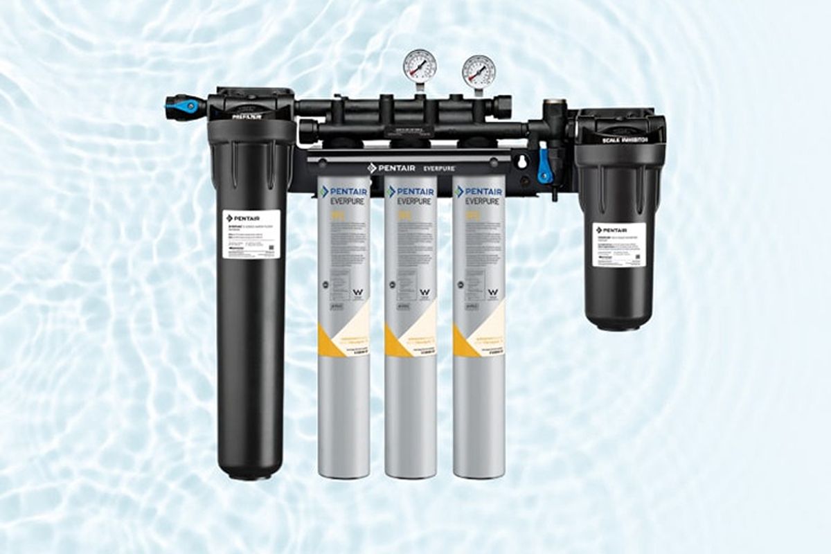 Pentair Everpure commercial water filtration system with multiple cartridges, pressure gauges, and black filter housings
