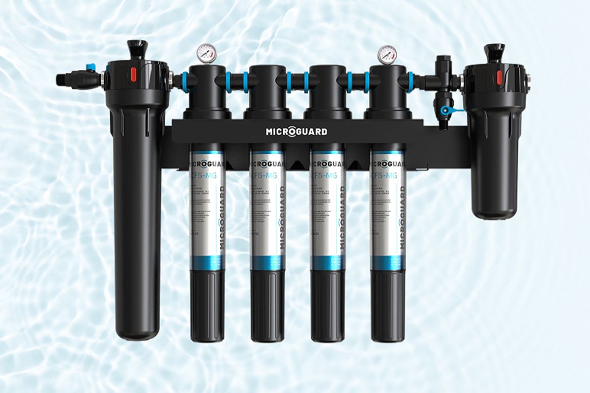 Microguard multi-cartridge water filtration system with black housings, pressure gauges, and membrane filters.
