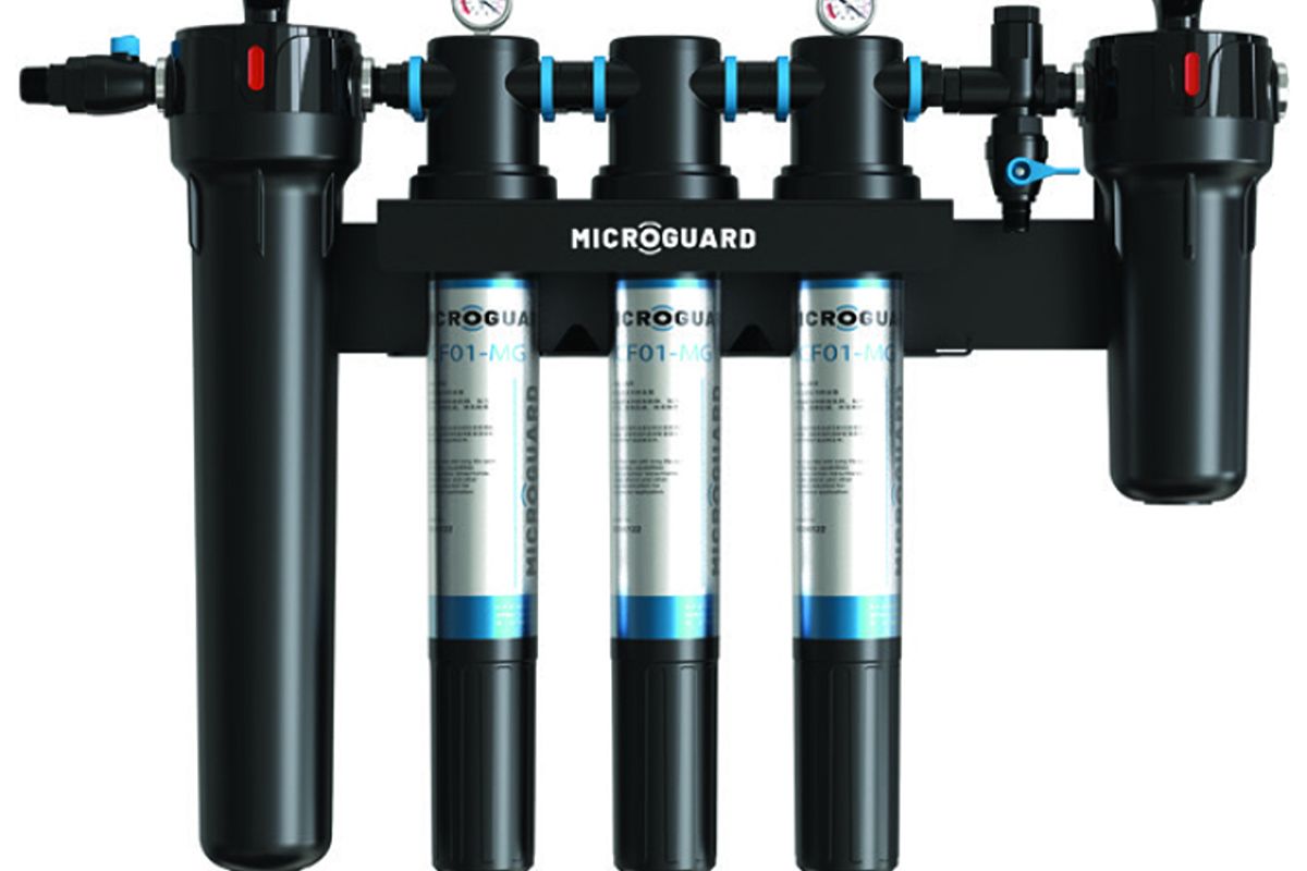MicroGuard commercial water filtration system with multiple cartridges, pressure gauges, and black filter housings
