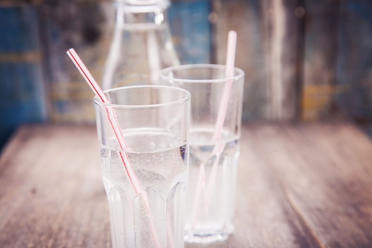 Glasses of water with straws on a table, representing safe and consistent beverage water quality